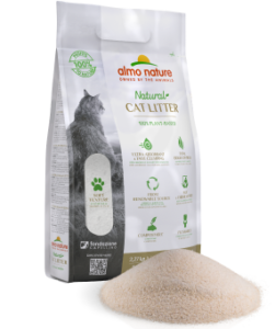 An Almo Nature cat litter package in white with green accents, showing "Naturale CAT LITTER" text. Next to the bag is a small pile of light-colored, fine-textured natural litter granules demonstrating the product's appearance.