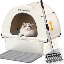 A white enclosed litter box branded "MEOWANT" features a dome-like design with a front opening.

A fluffy white cat with gray markings (likely a Ragdoll) is lounging inside the box.

The litter box comes with a large scooper and a gray litter mat placed in front.

There are orange arrows on the side indicating adjustable height or removable components.