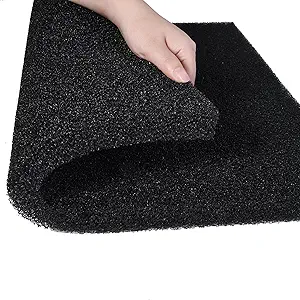 Black aquarium filter foam pad being held and folded by hand, showing porous sponge material texture for mechanical aquarium filtration